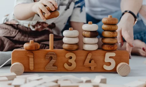 Mãe e filho a aprender juntos em casa usando técnicas ABA com brinquedos educativos
